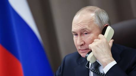 Russian President Vladimir Putin speaks on the phone